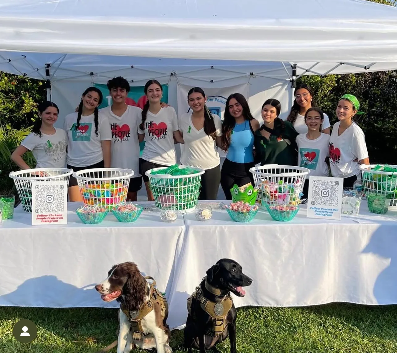 Love People Project youth volunteers at a community event table in Miami